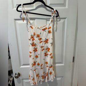 White sun dress with orange pattern